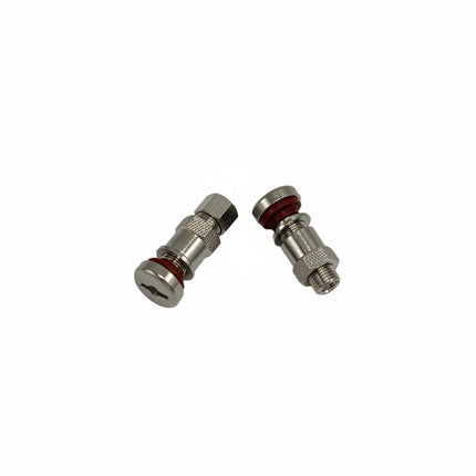 Two small metal components on a white background