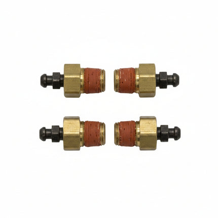 Four small brass and red components on a white background