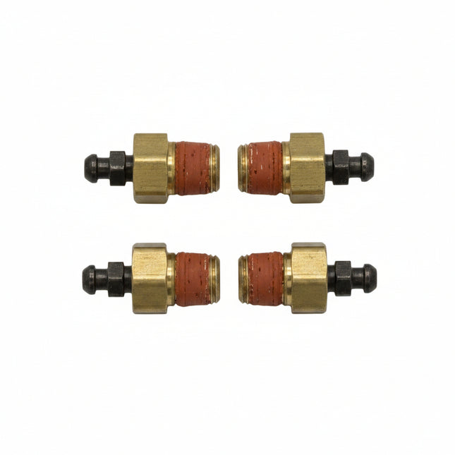 Four small brass and red components on a white background