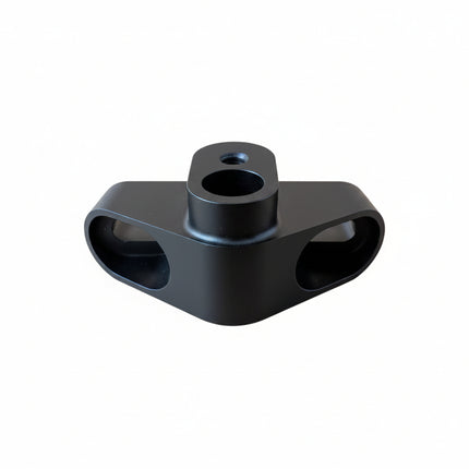 A matte black metal mounting bracket with a central cylindrical hole
